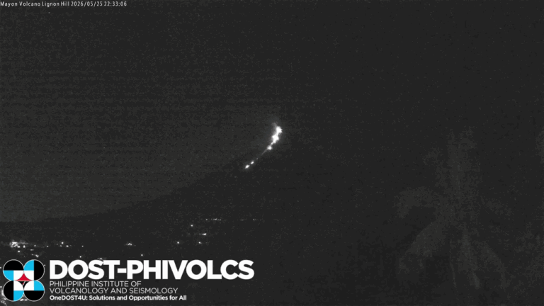 Looped black and white video footage showing a bright flash above a volcano