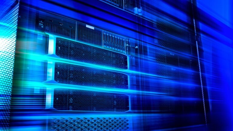 Blade server equipment rack in big data center neon cold blue tone in motion.