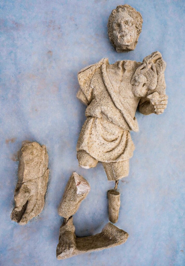 Fragments of a sculpture depicting a bearded man