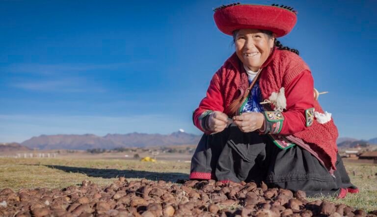 Peruvian woman preparing potatoes outside