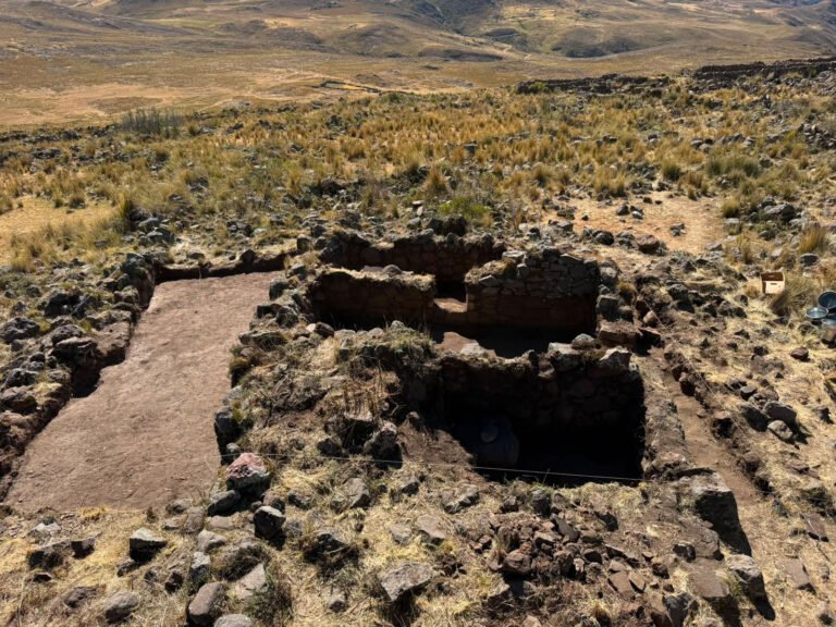 Excavated Huaylas house in Ancash, Peru, with view of surrounding landscape in the background